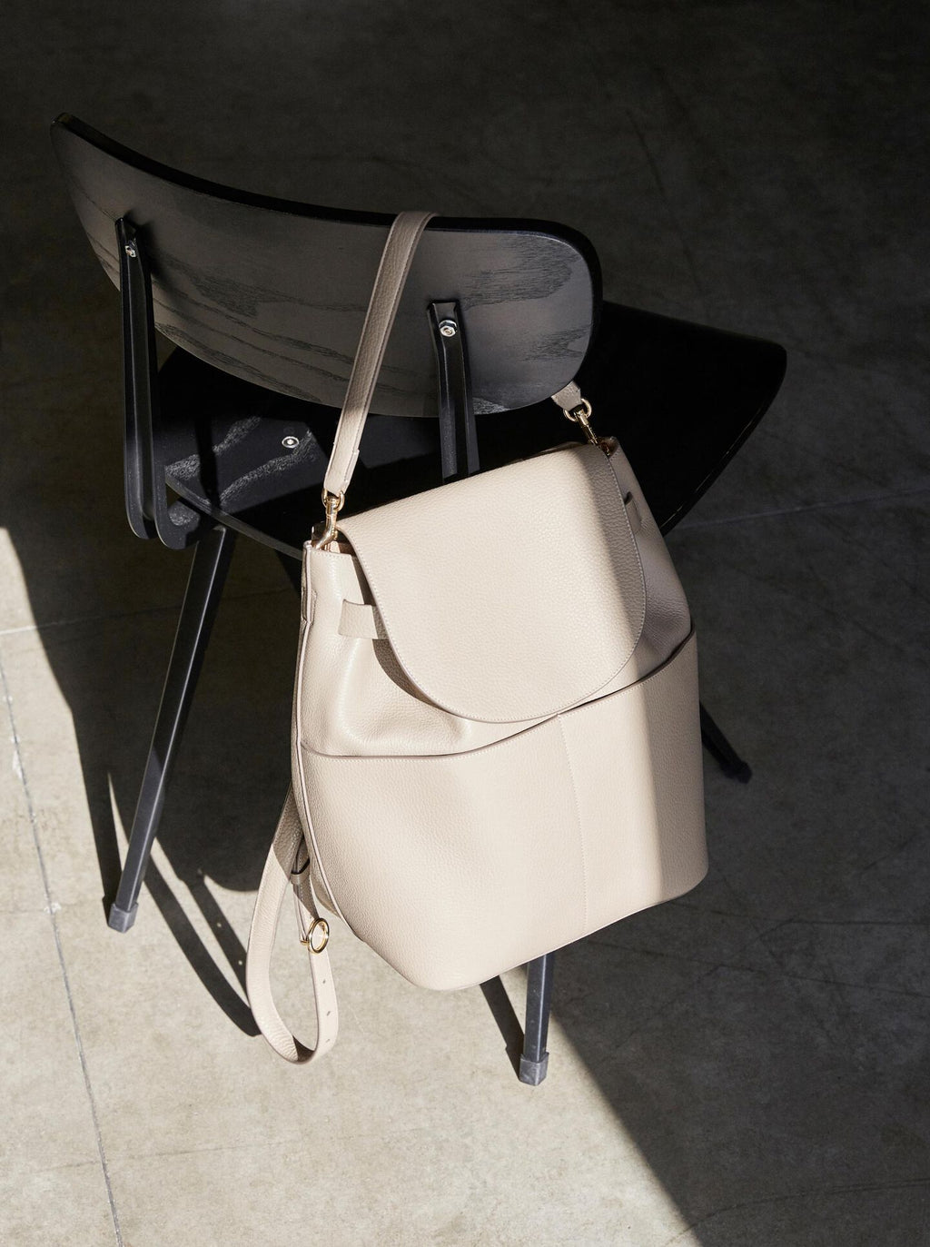 Handbag on a chair in a sunlit room.