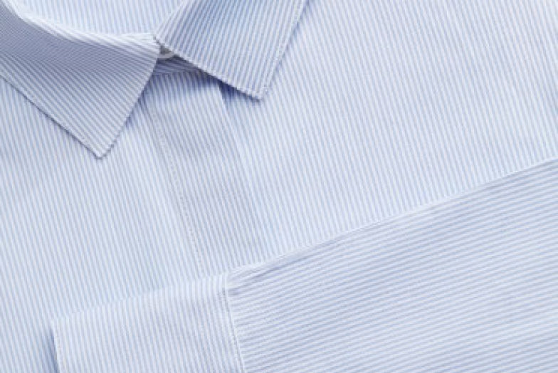 Close-up of a collared shirt with button and seam details.