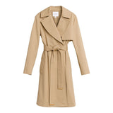 Trench coat with collar and waist belt on white background.