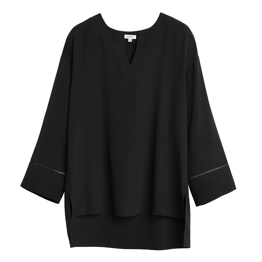 Long-sleeved blouse with a V-neckline and extended rear hem.