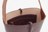 Open handbag with visible inner pouch and brand label.