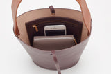 Open handbag with a smartphone and wallet inside.