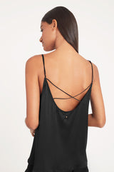 Woman showing the back of a strappy top.
