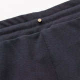 Close-up of trousers with a button on the waistband.
