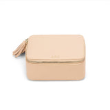 Small square cosmetic bag with zipper and tassel, labeled 'ARC'.