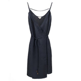 Sleeveless dress with spaghetti straps and wrap design with tie at waist.