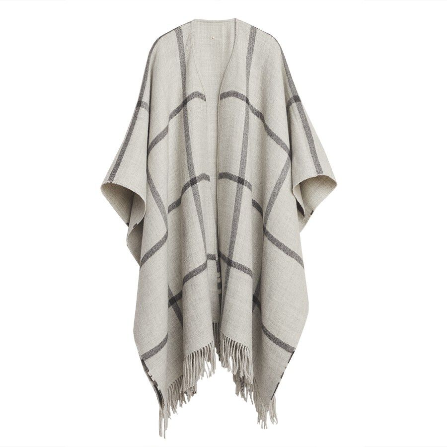 Cape with a draped design and fringed hem, displayed on a white background.
