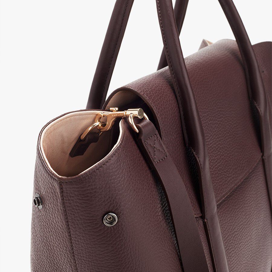 Close-up view of a handbag with a zipper and handle.