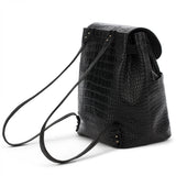 Black textured backpack with a shoulder strap and buckle detail.
