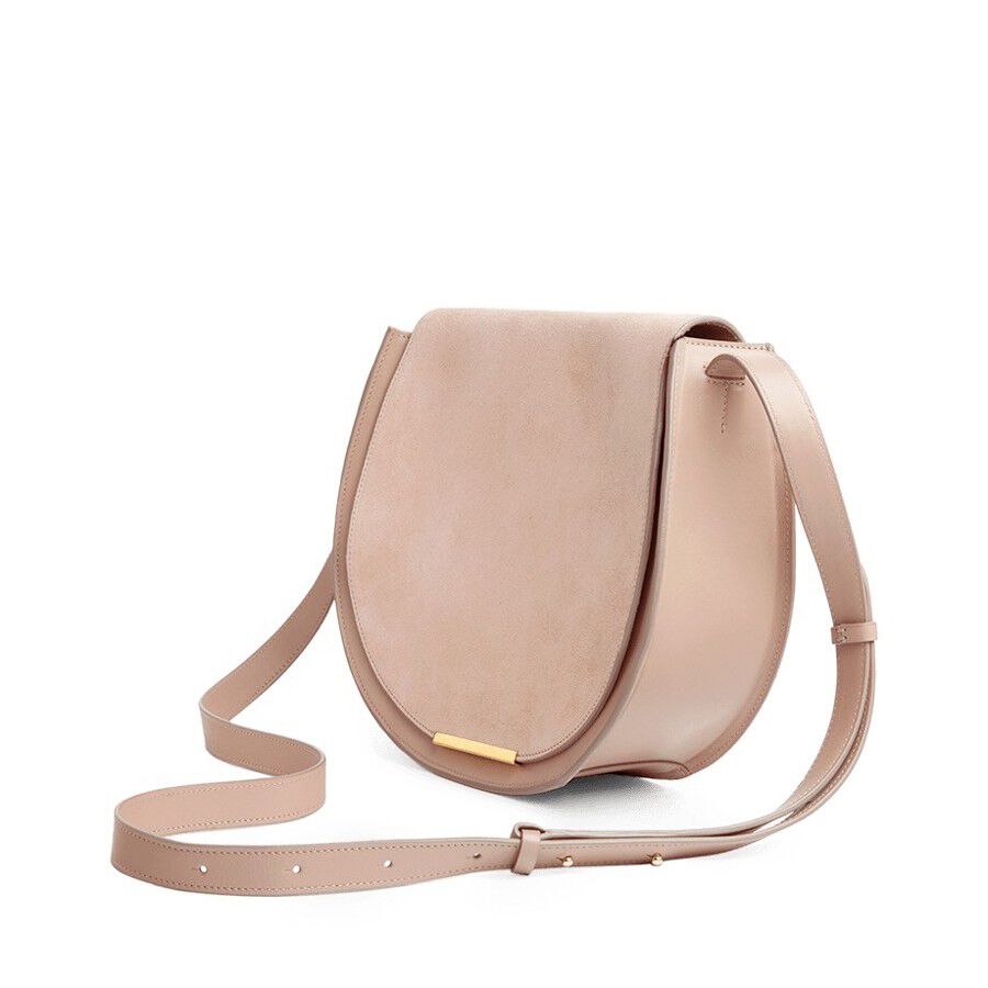 Round shoulder bag with adjustable strap and front clasp.