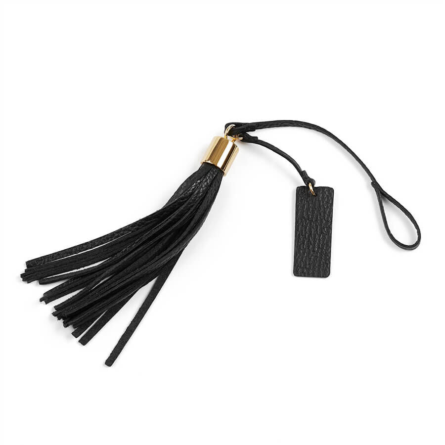 Tassel keychain with attached tag on a white background.