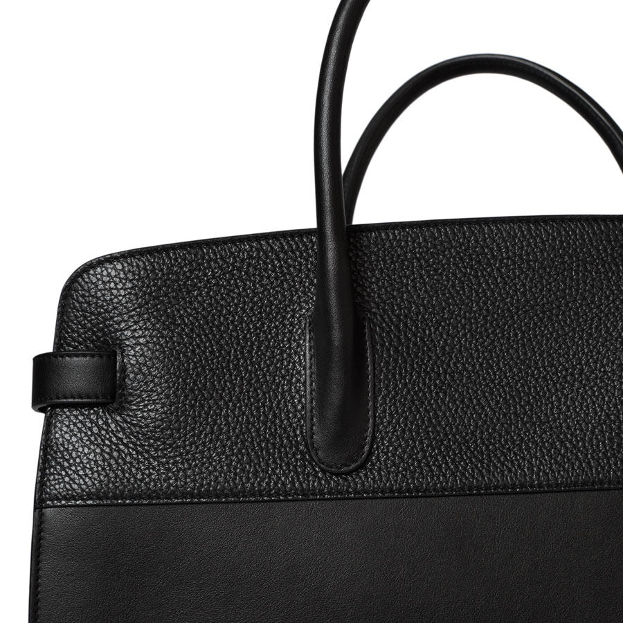 Close-up view of a handbag with a handle.
