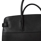 Close-up view of a handbag with a handle.