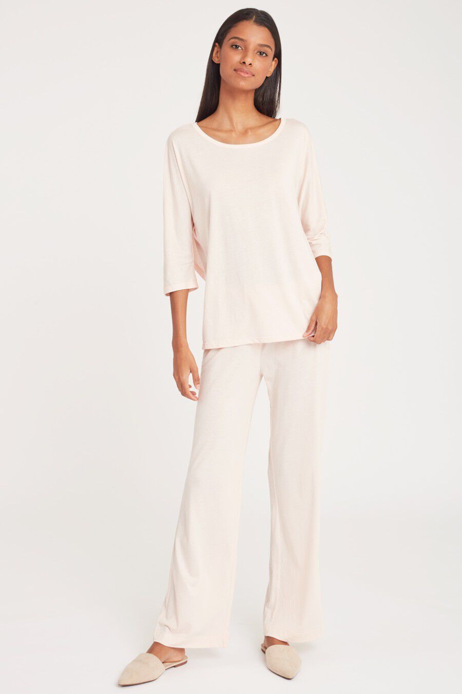Woman standing in a relaxed pose wearing a casual outfit.