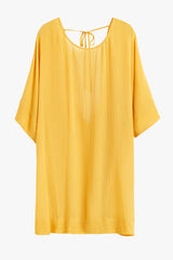 Short-sleeved blouse with a round neckline and tie detail at the back.