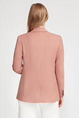 Woman viewed from behind, wearing a jacket and pants.