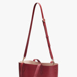 Handbag with a long adjustable strap and short handles.