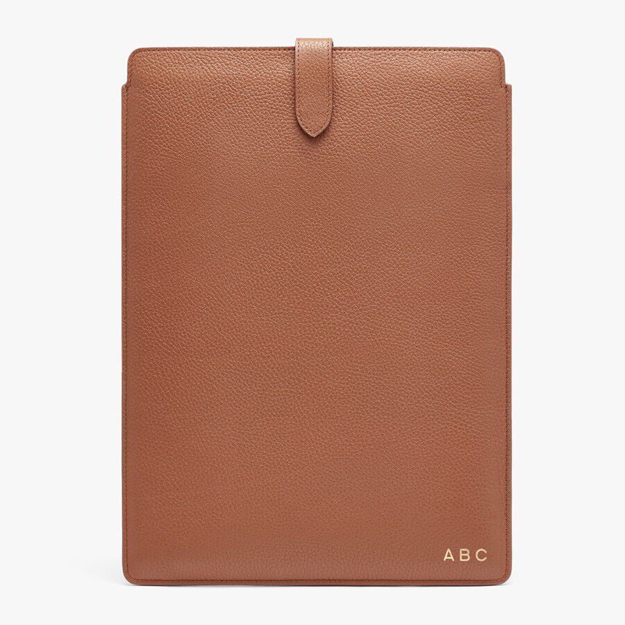 Leatherette tablet case with monogrammed initials and flap closure