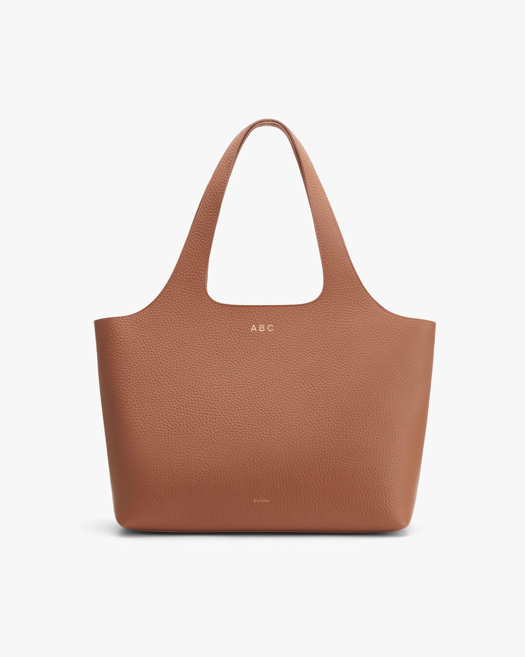 Caramel Italian leather work tote on neutral studio background