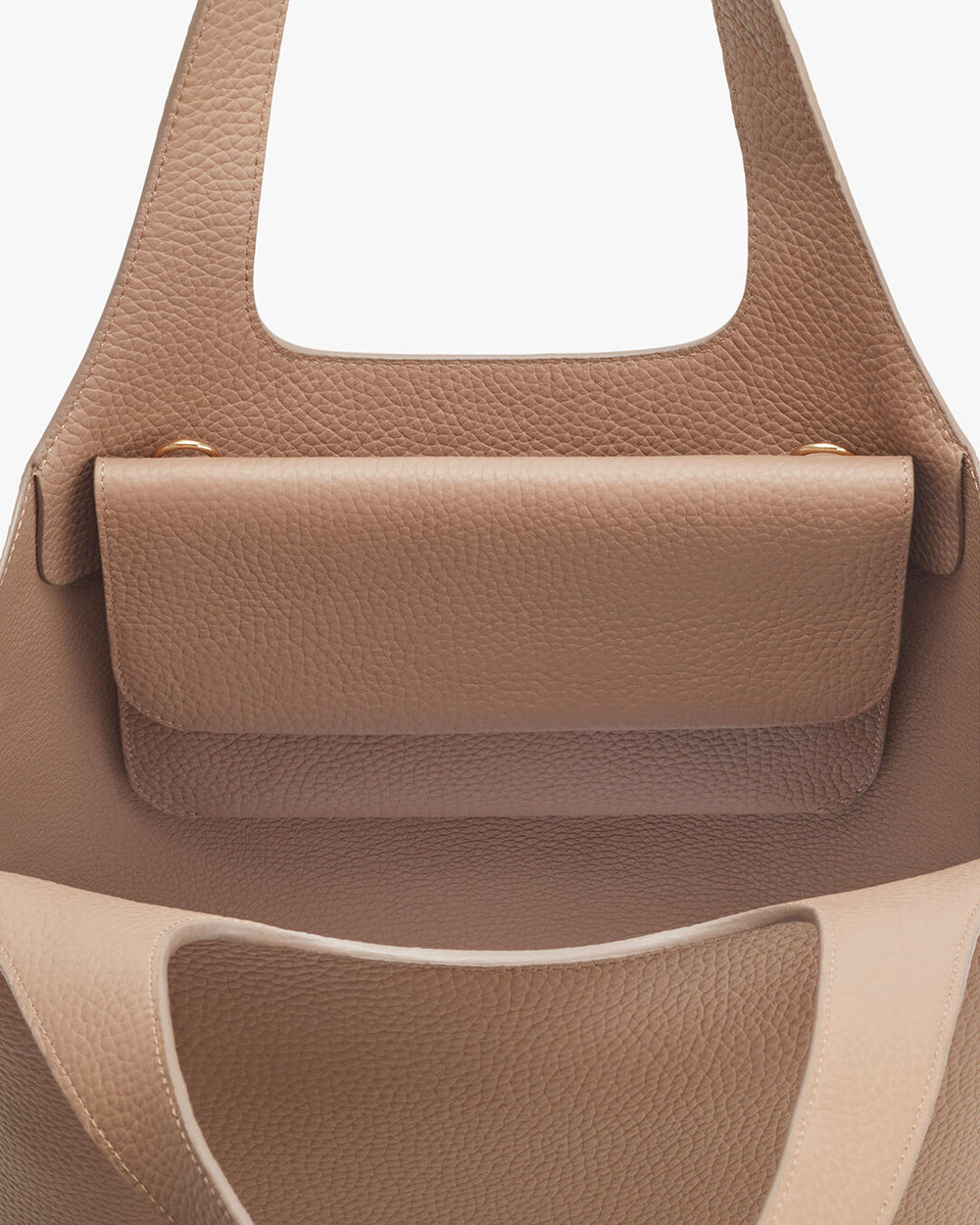 Close-up view of a handbag with a flap closure and structured handle.