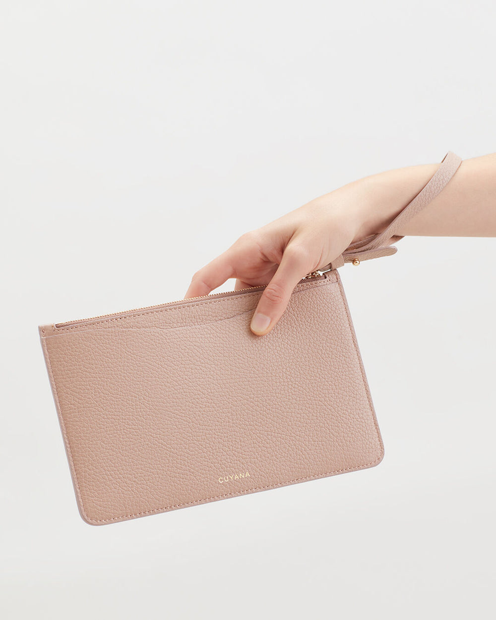 Hand holding a small clutch wallet