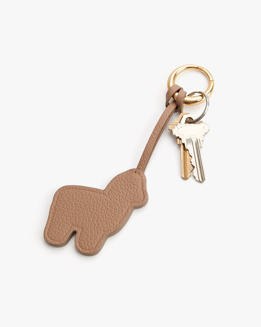 Keychain with animal shape and keys attached on a plain background.