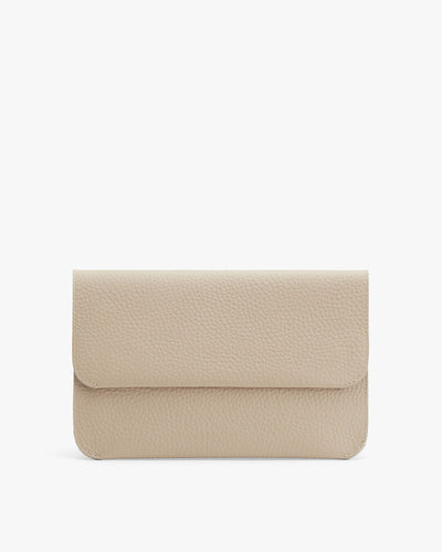 Leather wallet with flap closure on a plain background