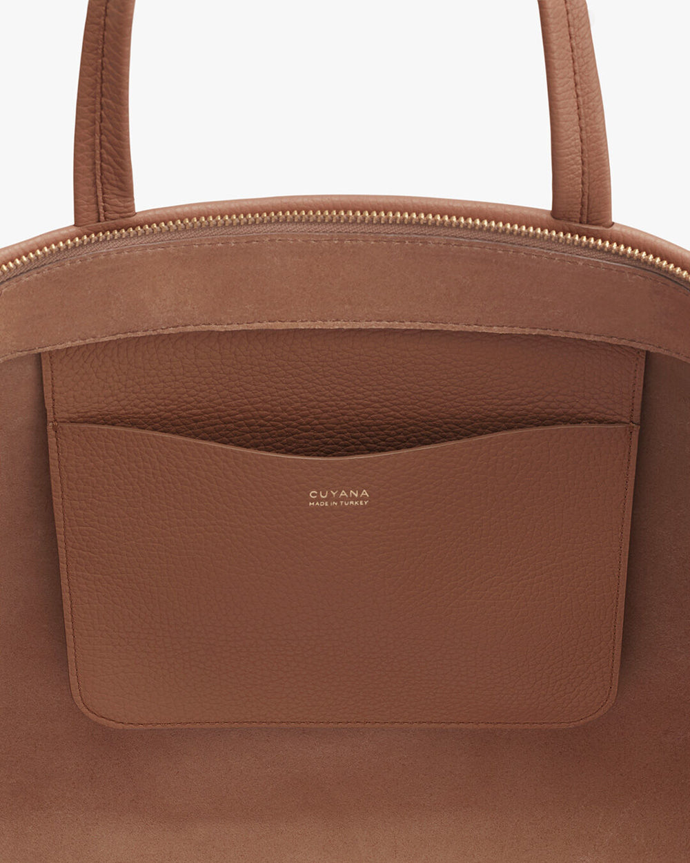 Close-up of a handbag with a brand logo and external pocket.