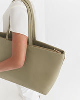 Person carrying a large tote bag