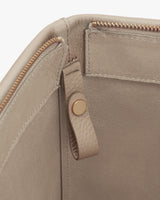 Close-up view of a bag's zipper and snap button closure.