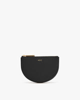 Small half-moon shaped purse with zipper and initials 'ABC' on front.
