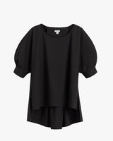Short-sleeved blouse with round neckline and layered hem on plain background