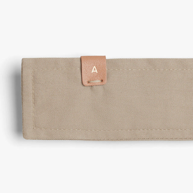 Rectangular wallet with a small labeled tab on the corner.
