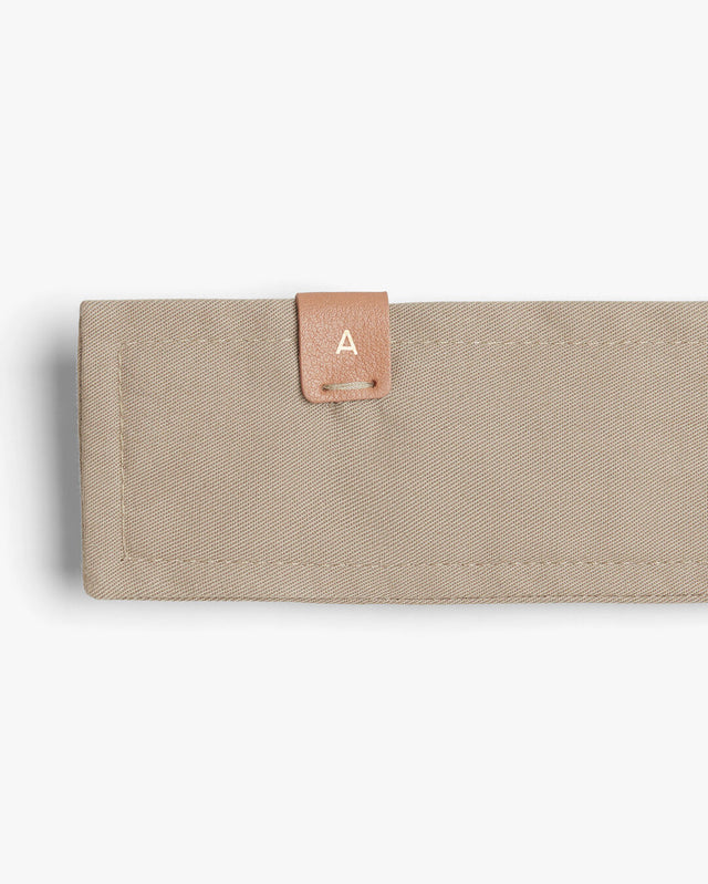 Rectangular wallet with a small labeled tab on the corner.