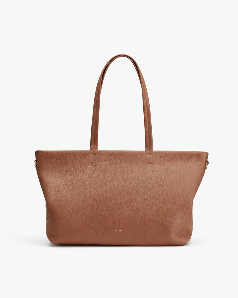Large tote bag with two handles, standing upright against a neutral background.