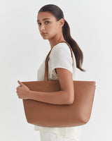Woman holding a large tote bag over her shoulder