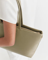 Person holding a shoulder bag