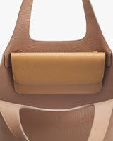 Close-up view of a handbag with a textured flap closure.