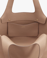 Open handbag showing inner pocket and handles.