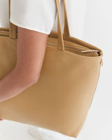 Person holding a large tote bag.