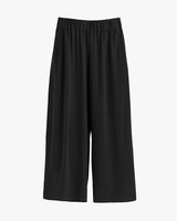 Wide-leg trousers with elastic waistband on plain background