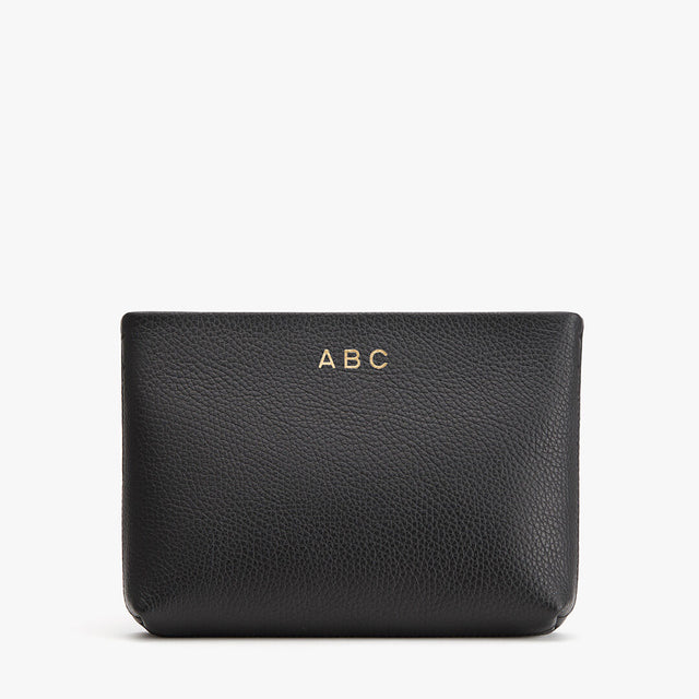 Personalized leather pouch with initials 'ABC' embossed on it.