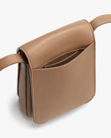 Small handbag with a shoulder strap and visible pocket