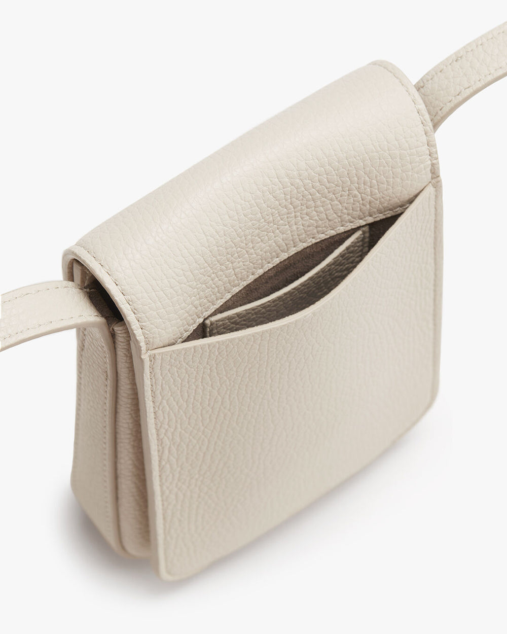 Small handbag with flap open, revealing interior.