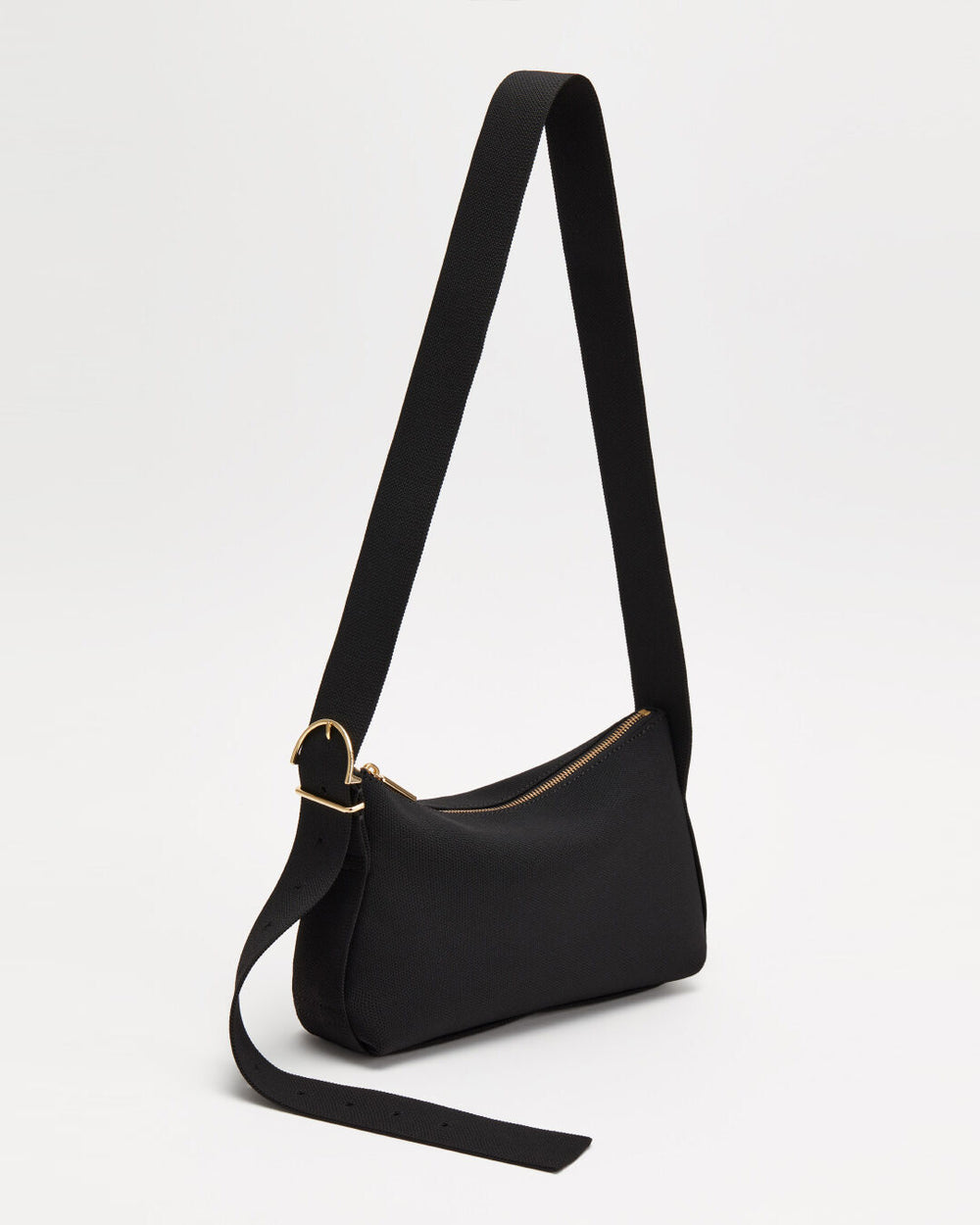 Small shoulder bag with a long strap and gold-tone hardware.