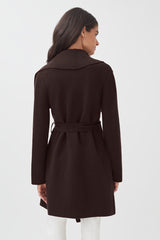 Woman seen from behind wearing a belted coat