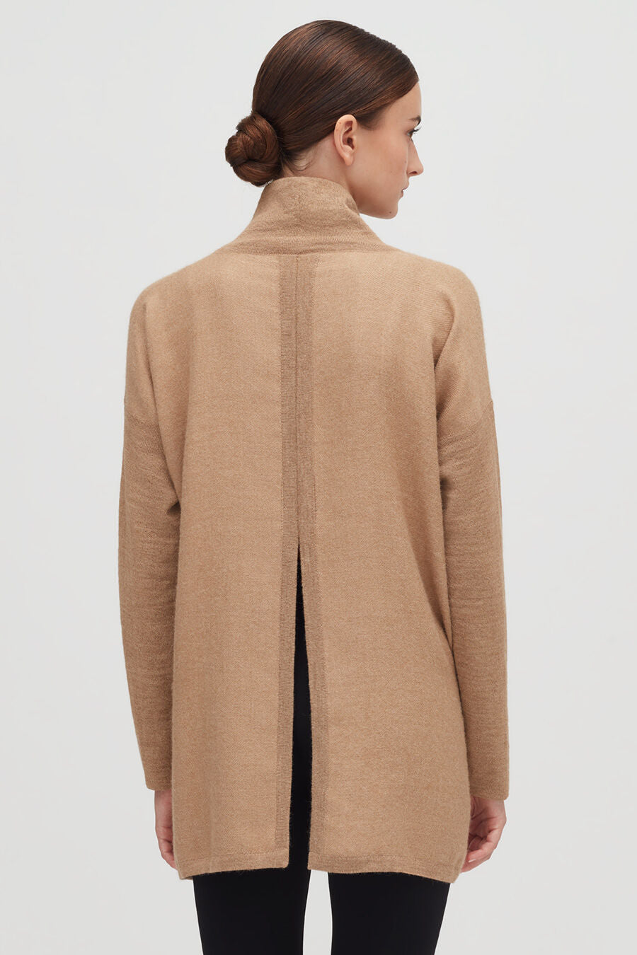 Woman in a high-neck jacket viewed from the back