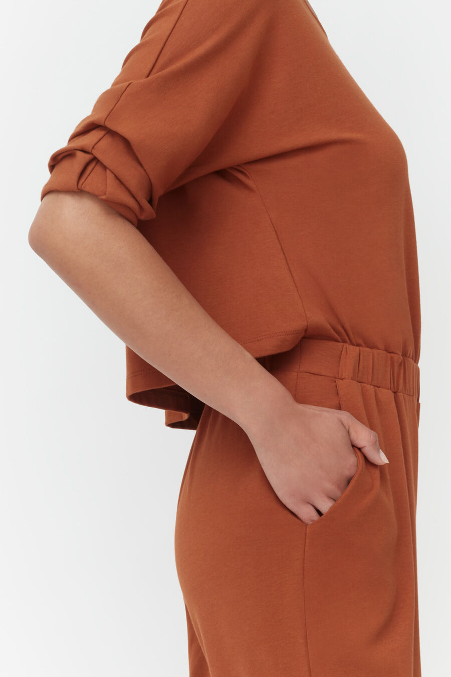 Person with hand in pocket, partial side view.