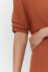 Close-up of a person with a hand on their hip.