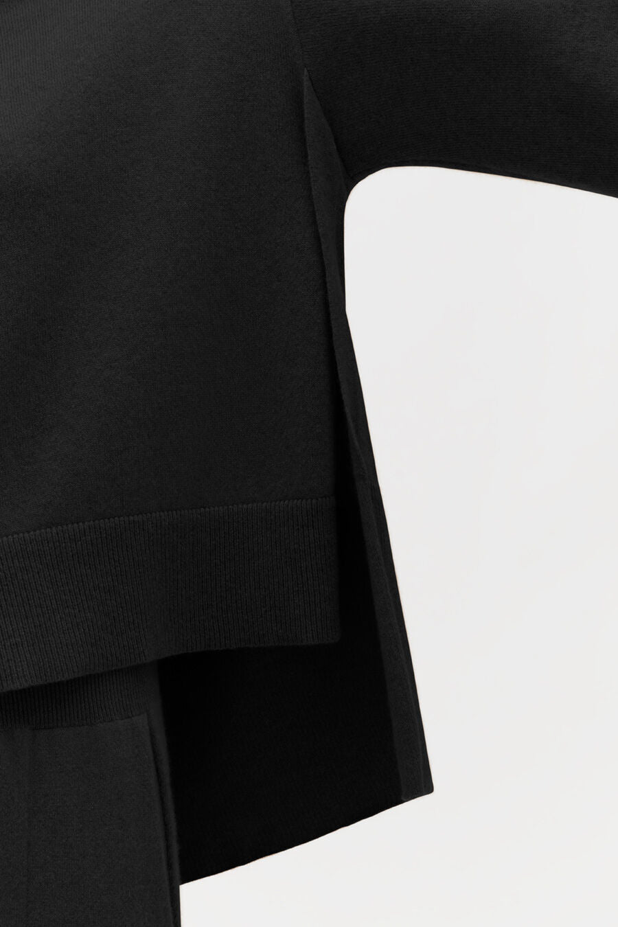 Close-up of a sleeve and side seam of a garment.